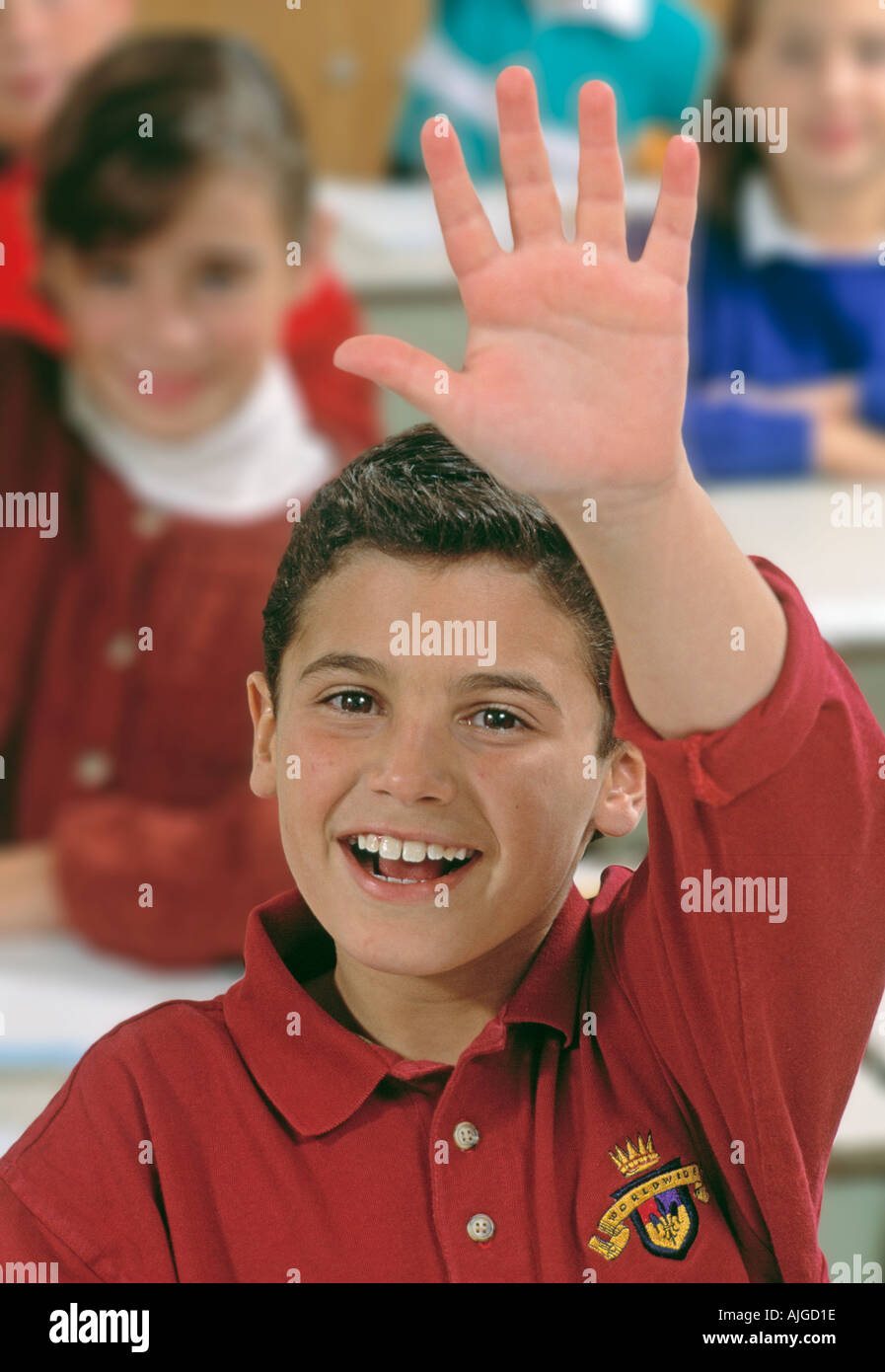 Caucasian male student raising hand in class Stock Photo