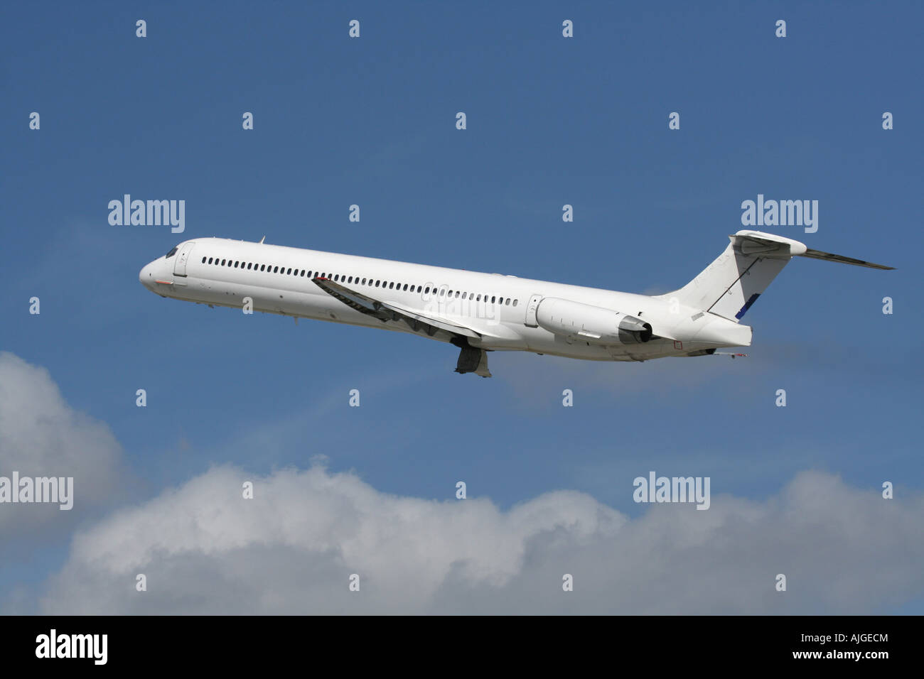 Commercial air travel. McDonnell Douglas MD-83 passenger jet plane in the air. No livery and proprietary markings removed. Stock Photo