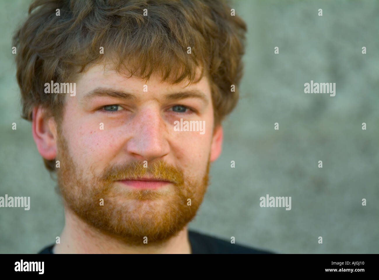 portrait of a scruffy unkept young man with beard and unkept hair Stock Photo