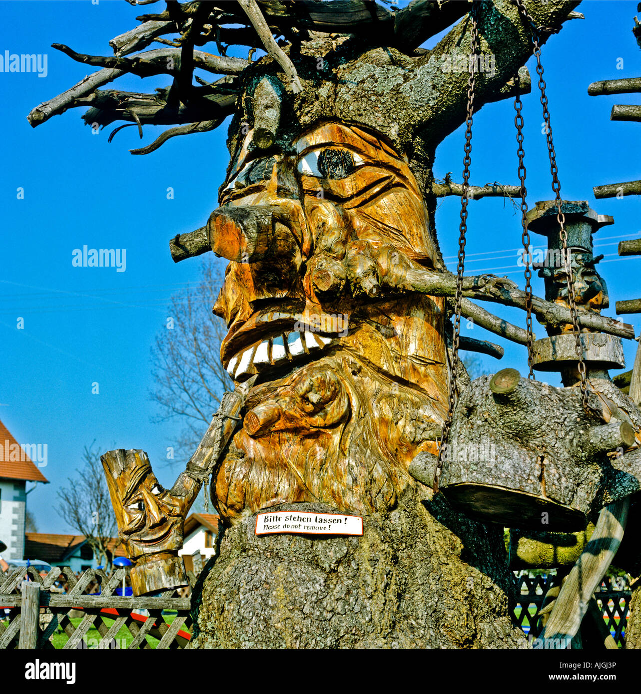 Grotesque face carved in a dead tree trunk in Bavaria Germany Europe EU Stock Photo