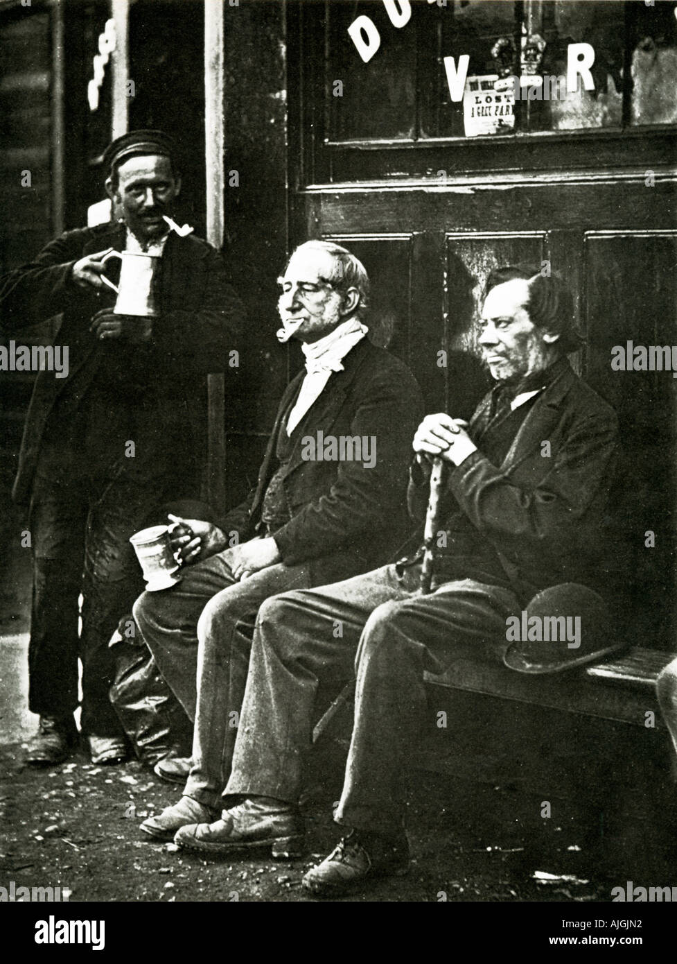 A London Pub, 1876 Victorian photograph of three beer drinkers outside their hostelry watching the world go by Stock Photo