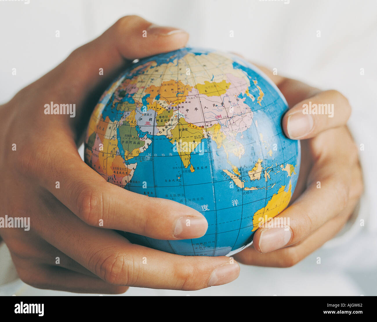Hands holding up globe hi-res stock photography and images - Alamy