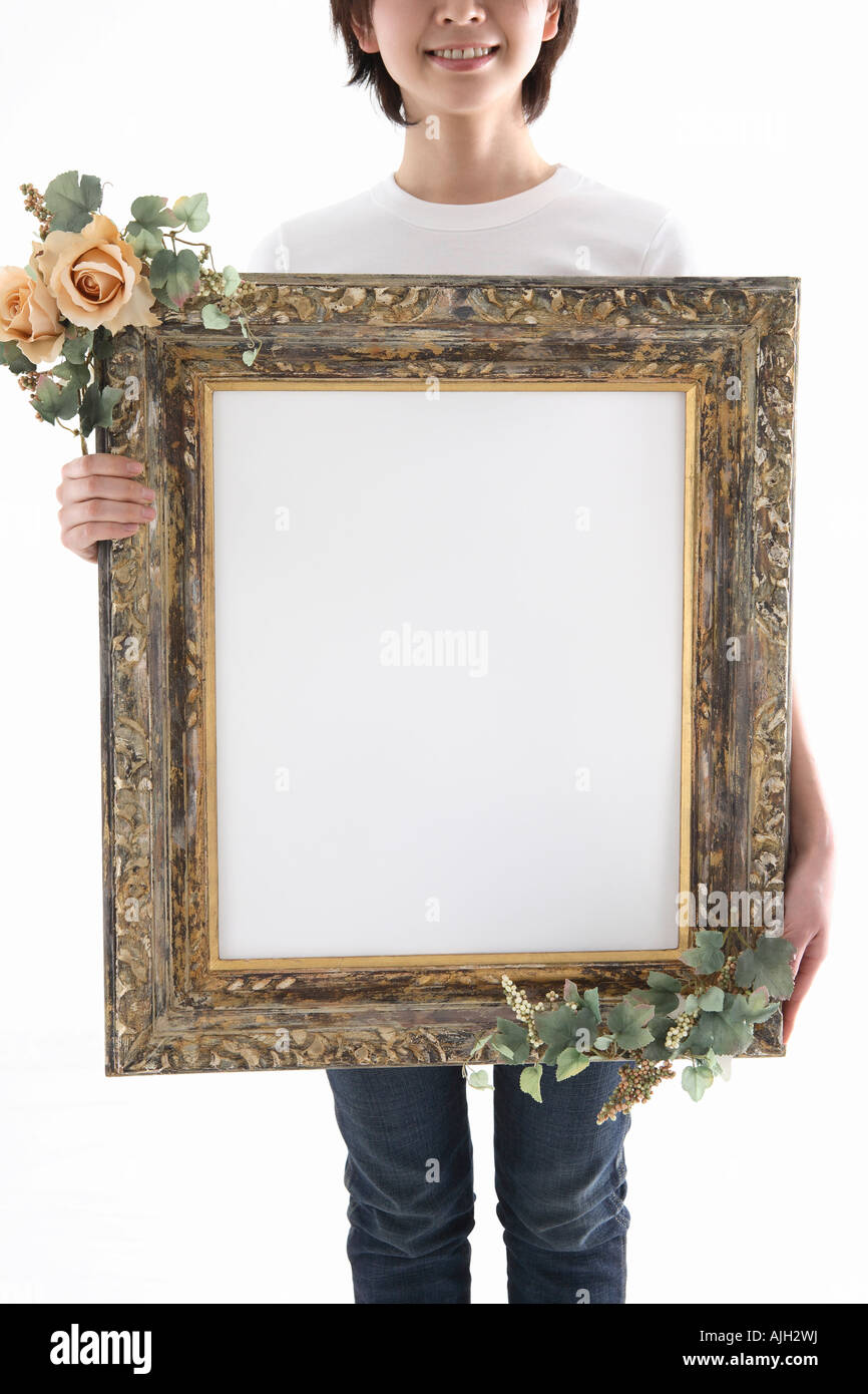 Woman holding picture frame Stock Photo