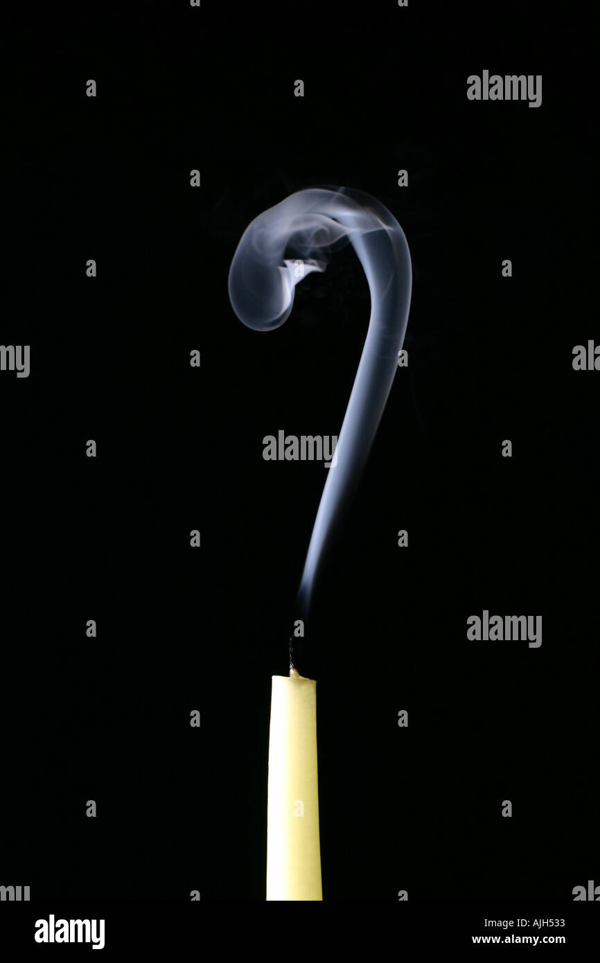 Candle smoking with smoke forming a question mark Stock Photo Alamy