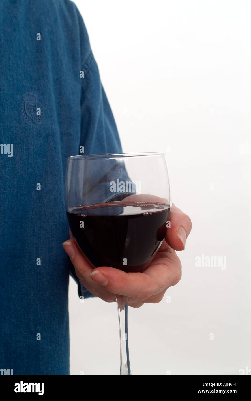 hand holding a glass of red wine Stock Photo