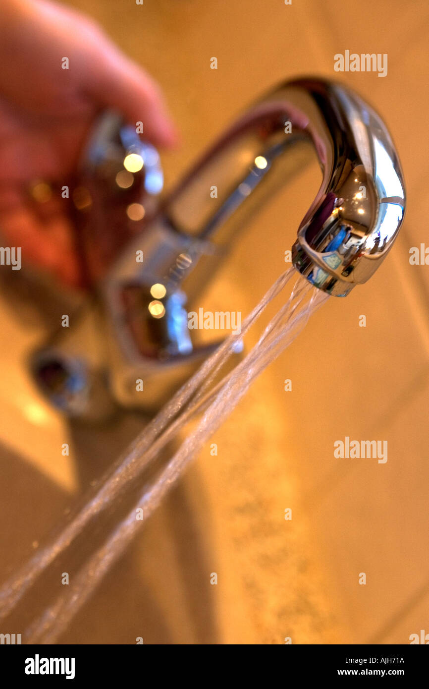 Turning off tap Stock Photo Alamy