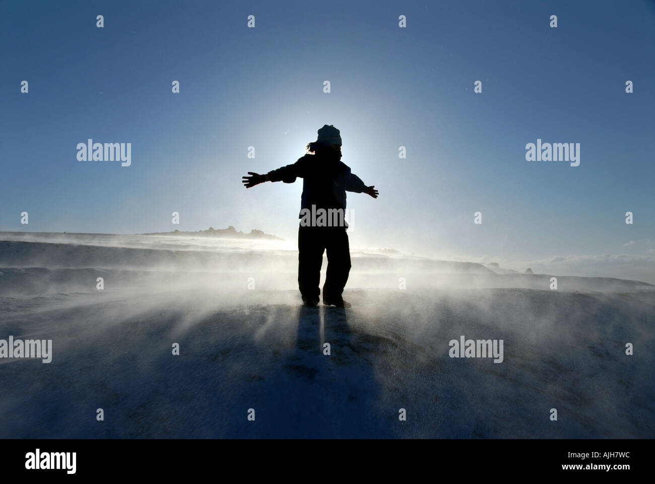silhouette figure on top of the world on a snowy Dartmoor. Stock Photo