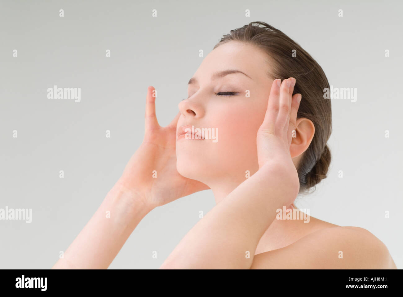 Young woman massaging temples Stock Photo