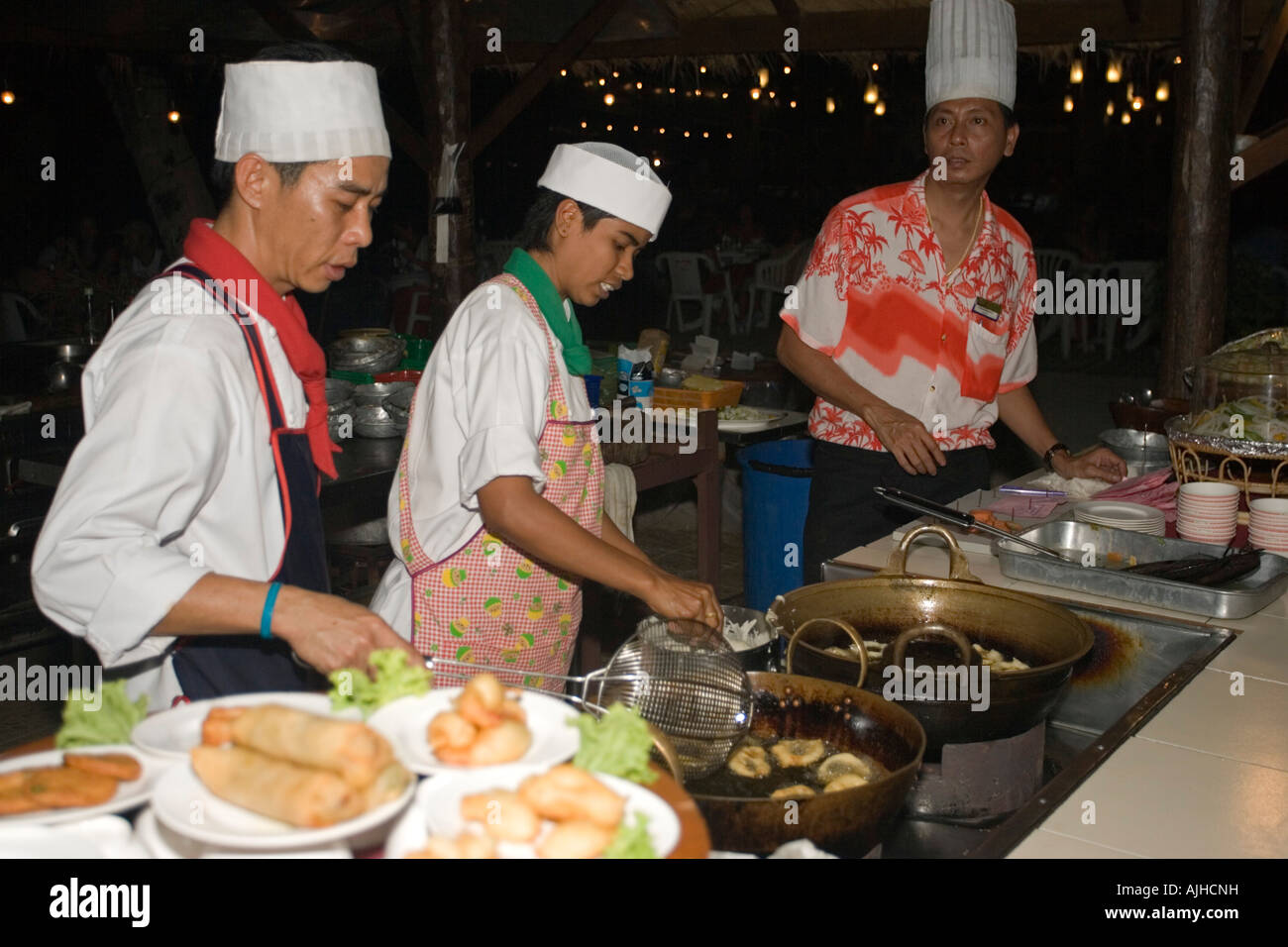 Chefs deep fry onion rings prawns seafood restaurant Ko Phi Phi island