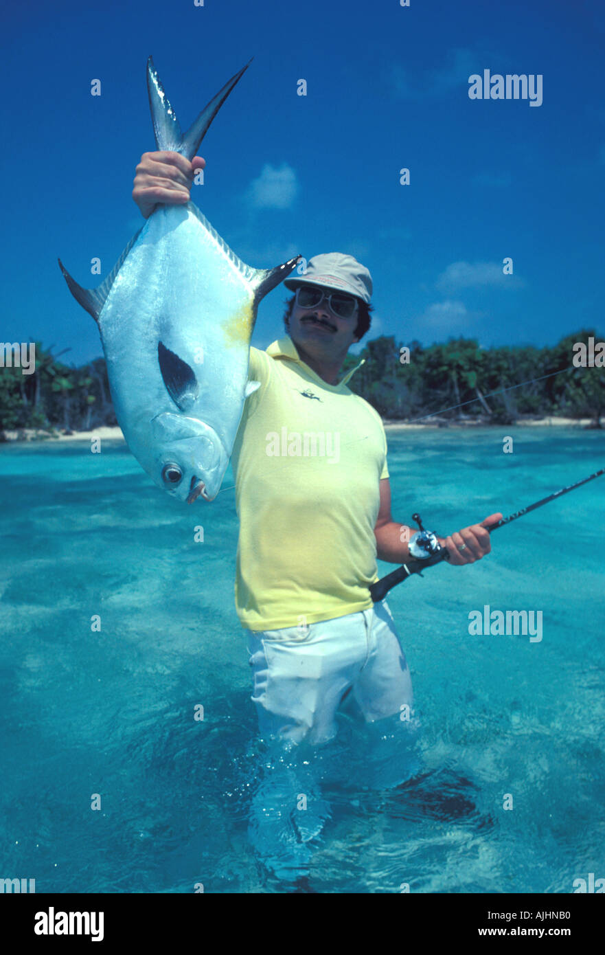 Fishing Belize Central America Turneffe Islands angler holding up large permit salt water gamefish fishing Stock Photo