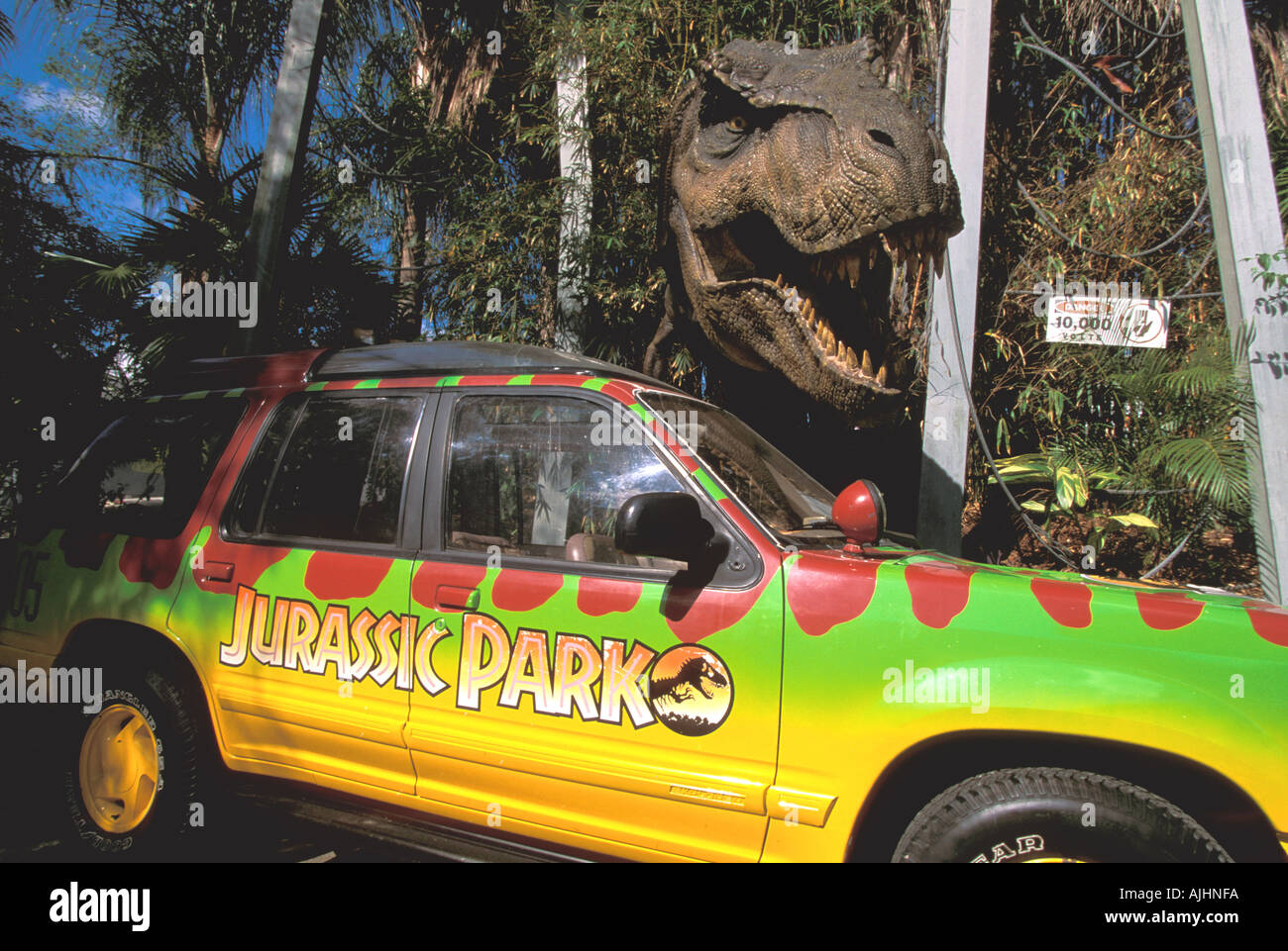 Orlando FL Florida Universal Studios Jurassic Park t-rex dinosaur standing over wrecked car movie scene from movie film Stock Photo