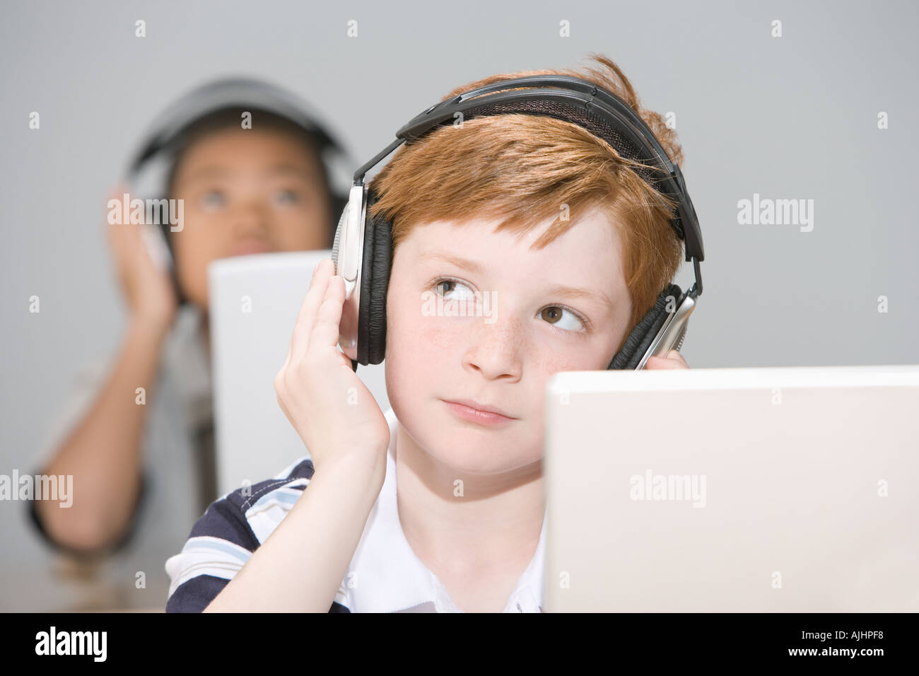 Boys listening to headphones Stock Photo