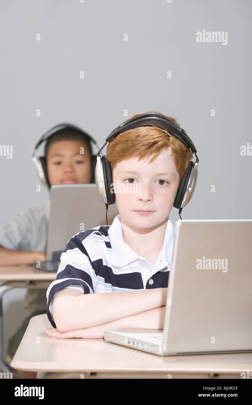 Boys with laptops and headphones Stock Photo