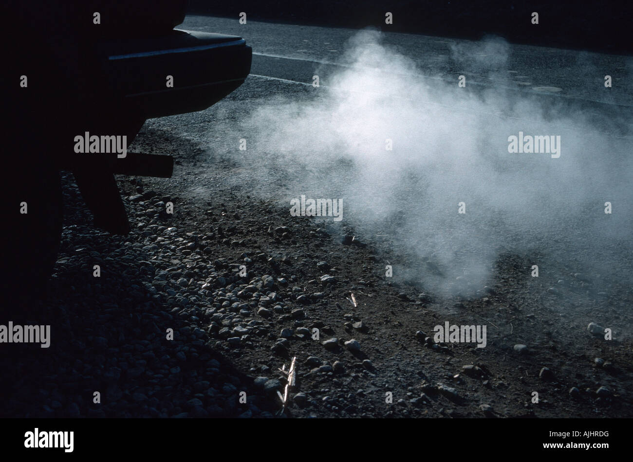 Exhaust fumes from tail pipe of car contain carbon dioxide and monoxide