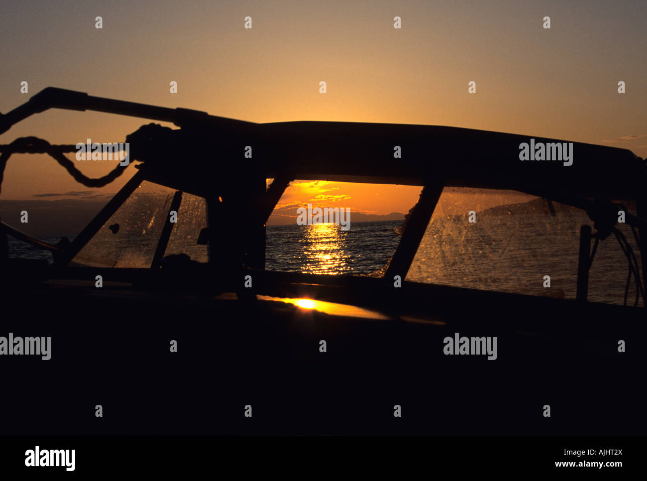A boat sit's while basking in a beutiful sunset Stock Photo - Alamy