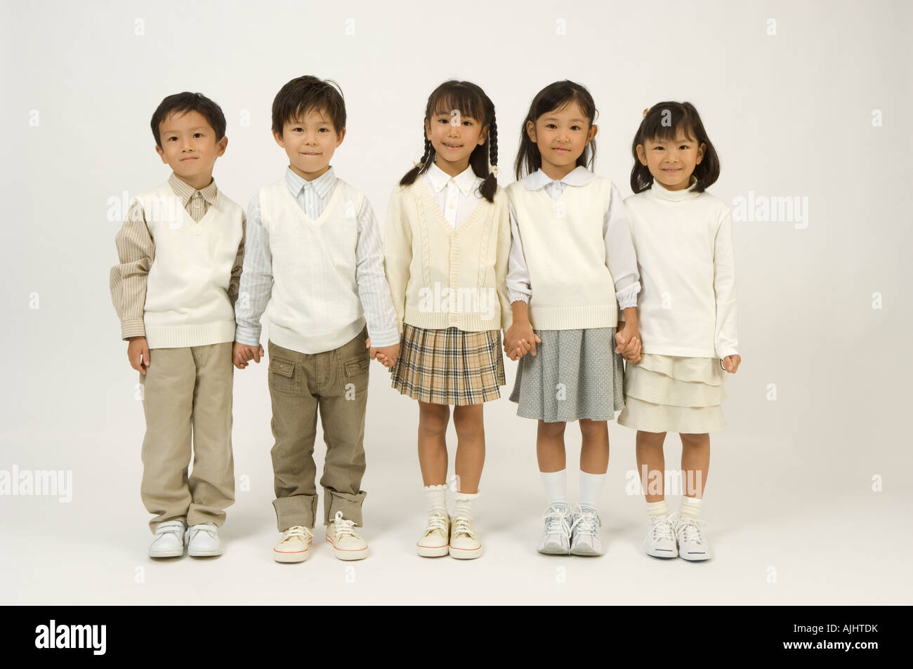 Five elementary age children standing Stock Photo - Alamy