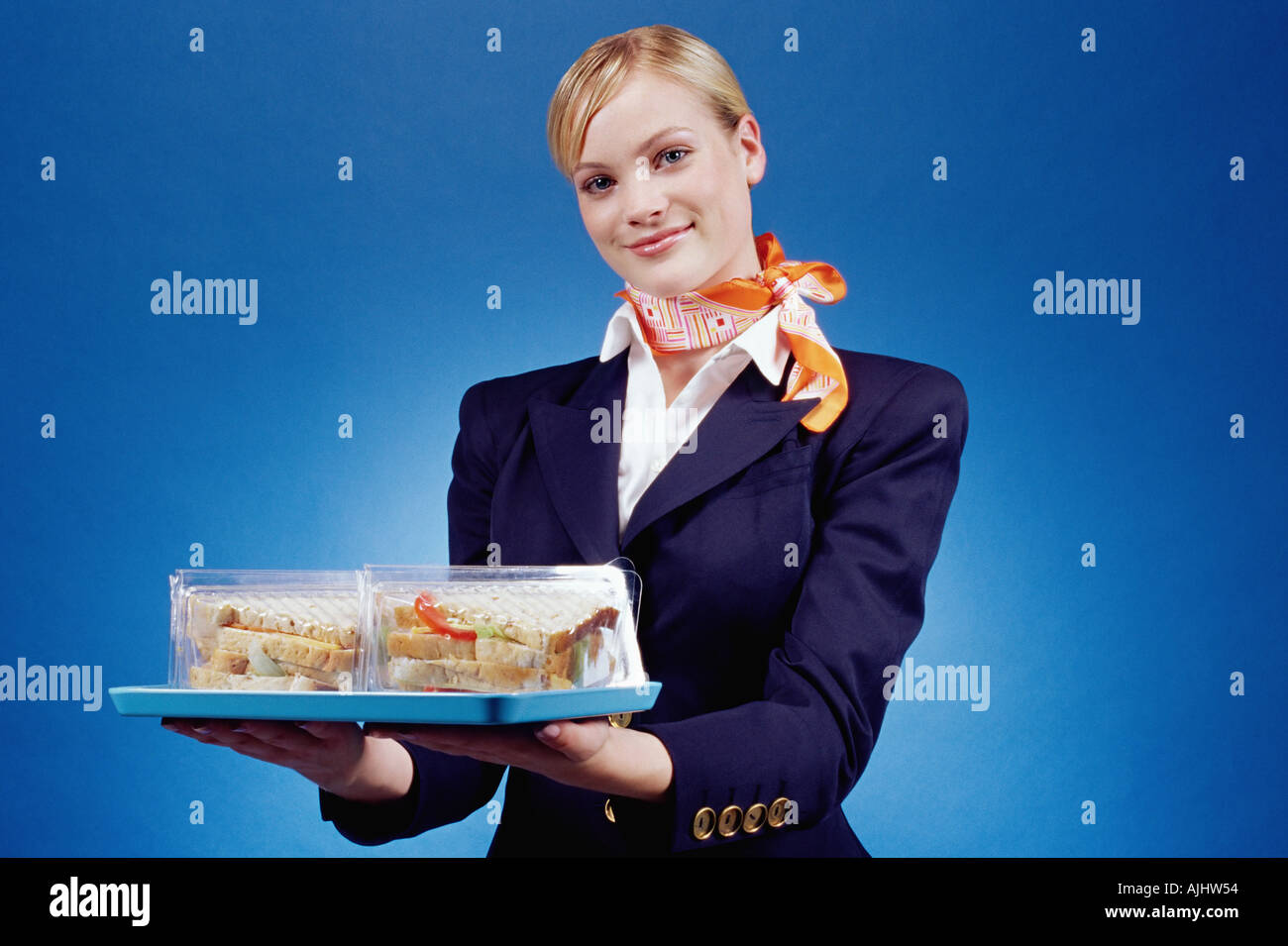 Air hostess holding a tray of sandwiches Stock Photo