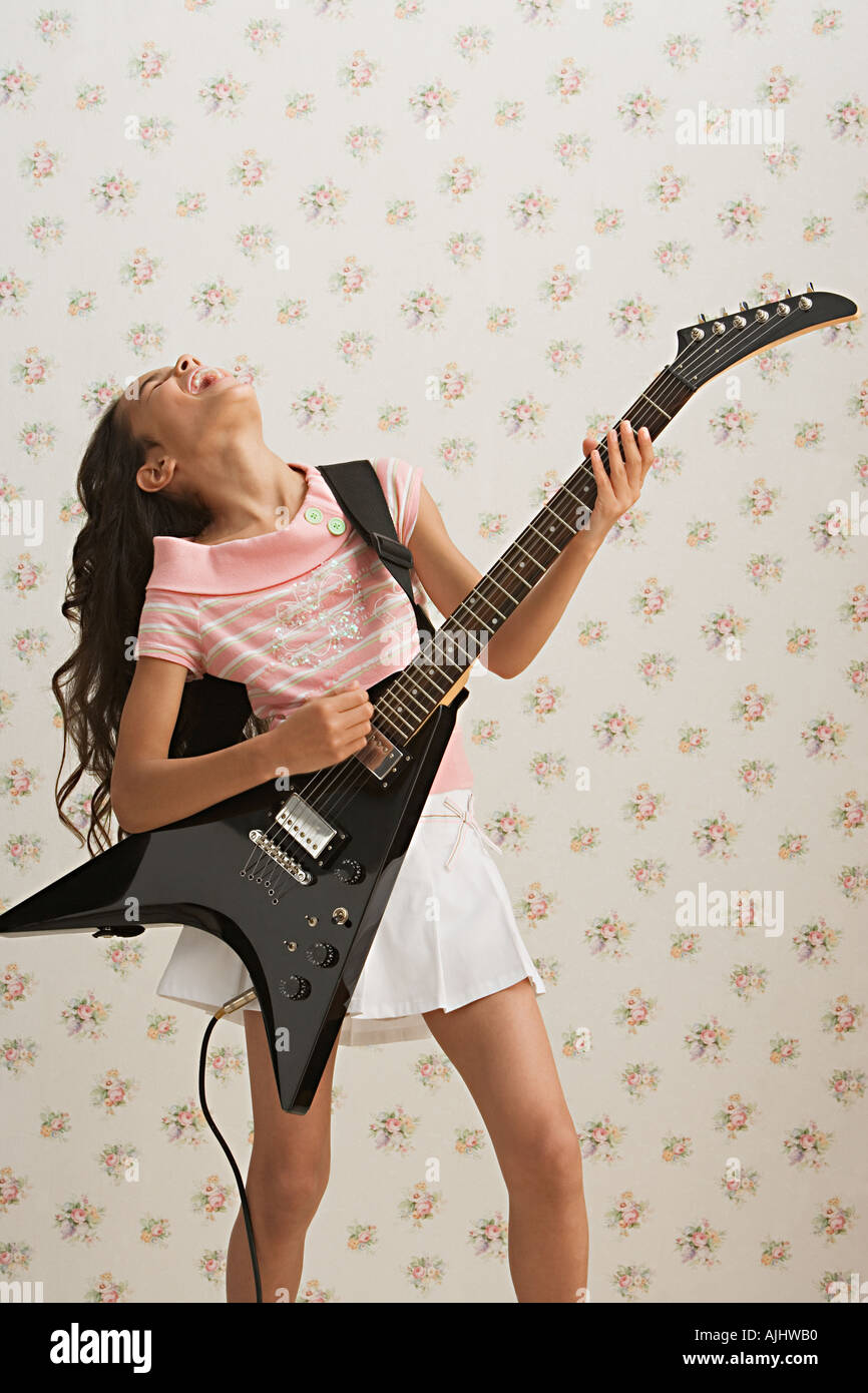 Girl playing electric guitar Stock Photo - Alamy