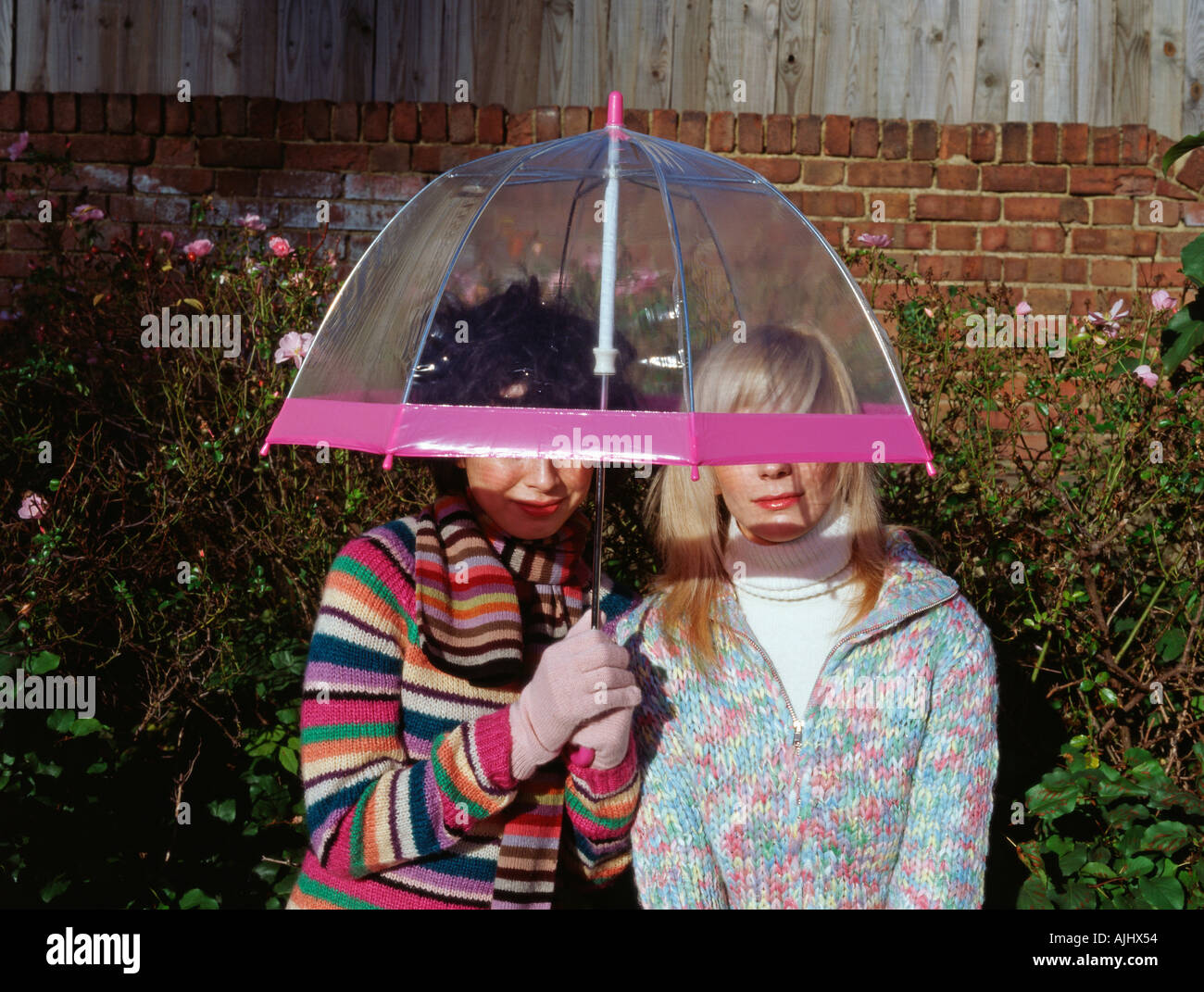 Two friends under an umbrella Stock Photo