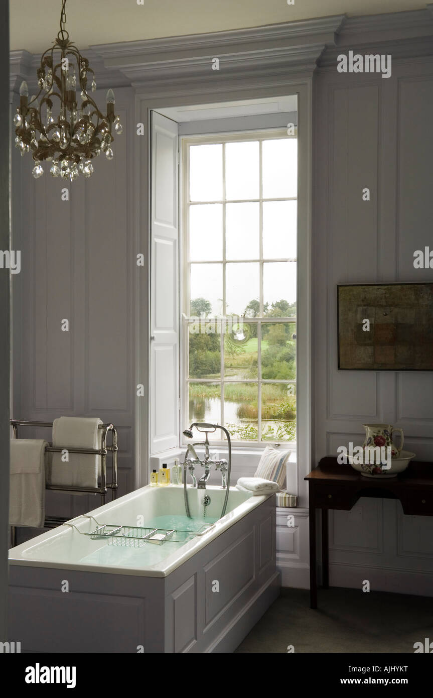 Bathroom with wood panelled walls and chandelier in Irish castle Stock Photo