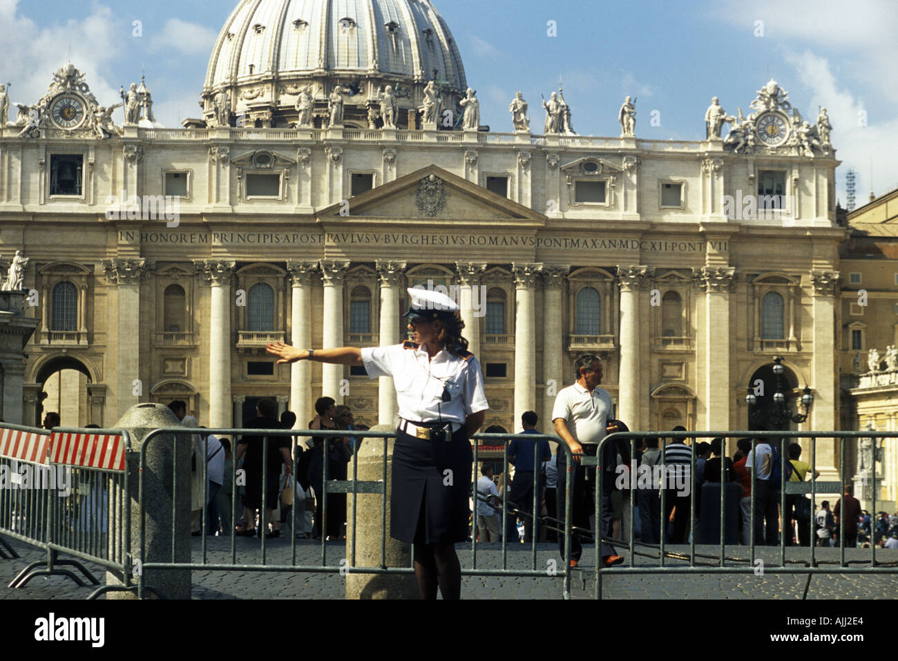 A female police officer directs traffic in front of Saint Peter s Square in Rome Italy Stock Photo