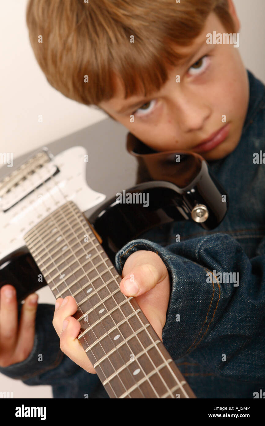 Young boy with electric guitar rock star attitude Stock Photo Alamy