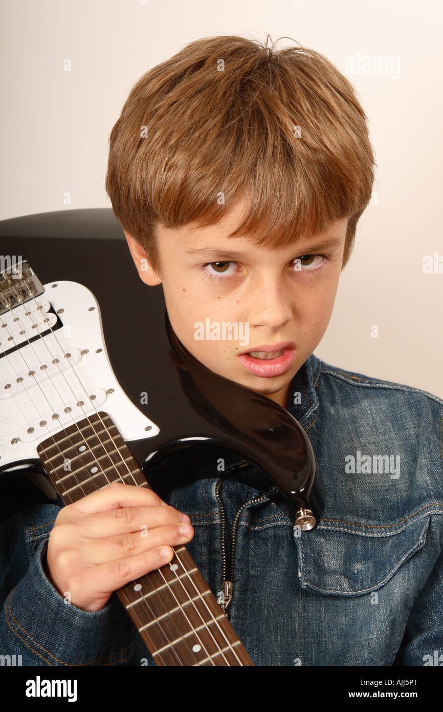 Young boy with electric guitar rock star attitude Stock Photo Alamy