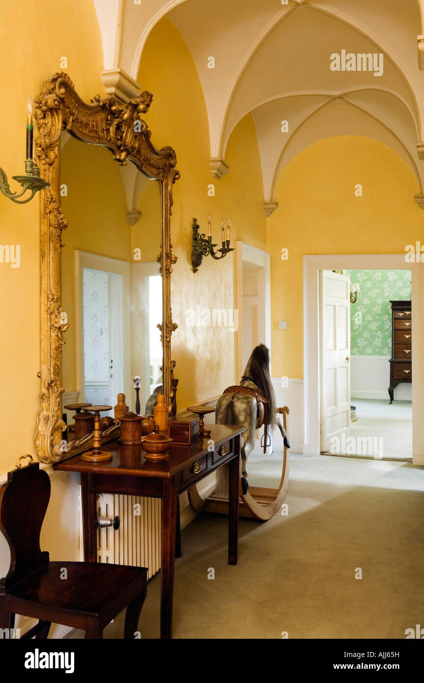 Gild mirror and rocking horse in hall with vaulted ceiling in 17th century Irish Castle Stock Photo