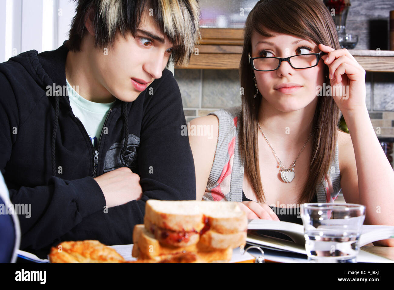 Sister helping her brother with homework Stock Photo