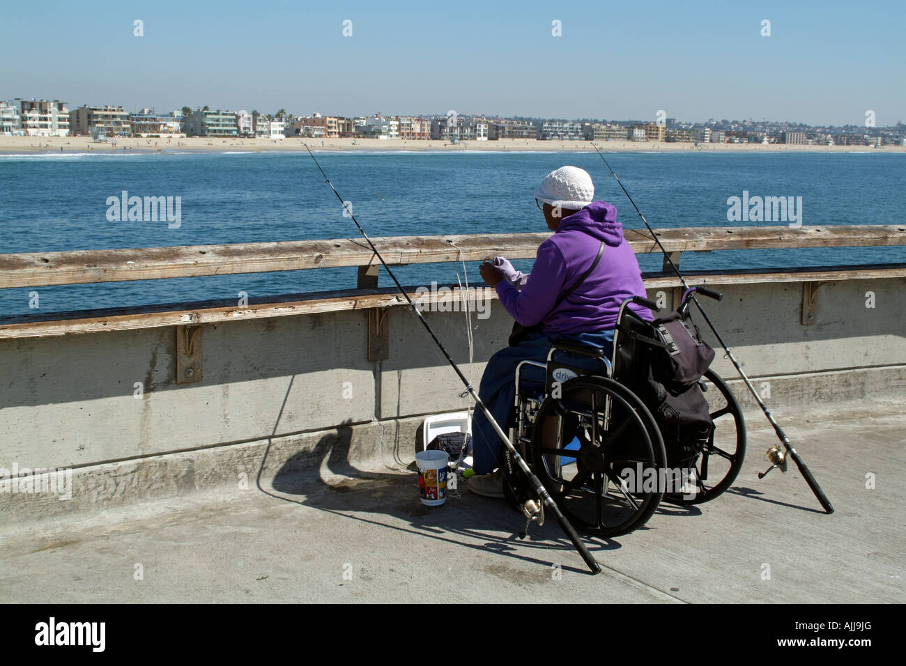 Woman in Wheelchair Fishing at Venice Beach Pier California USA Stock