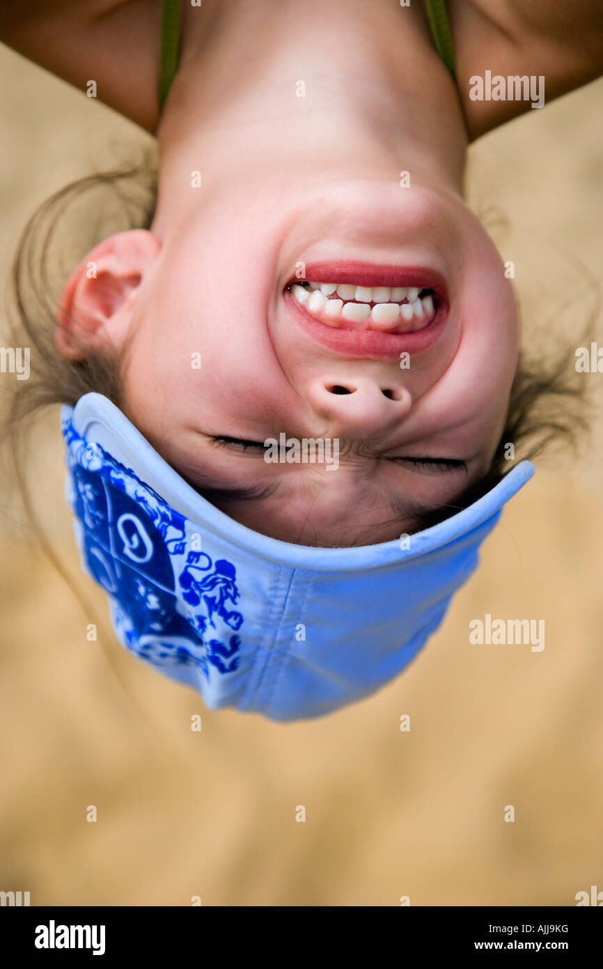 Girl hanging upside down Stock Photo