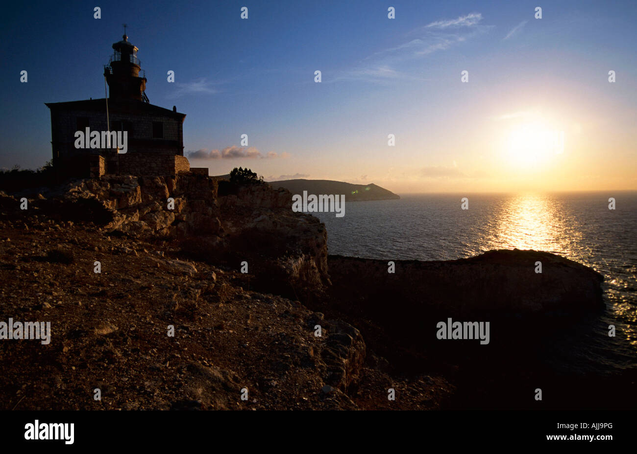 Leuchtturm auf Susac, Kroatien, am Abend | Lighthouse on Susac, Croatia, in the Backlight Stock Photo