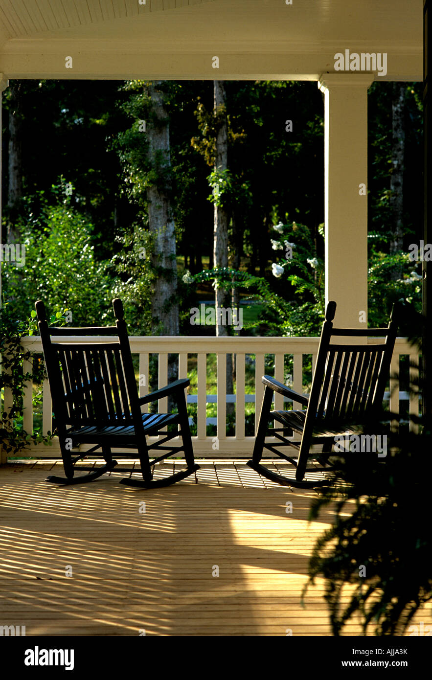 Wooden rocking chairs on veranda with garden view Stock Photo