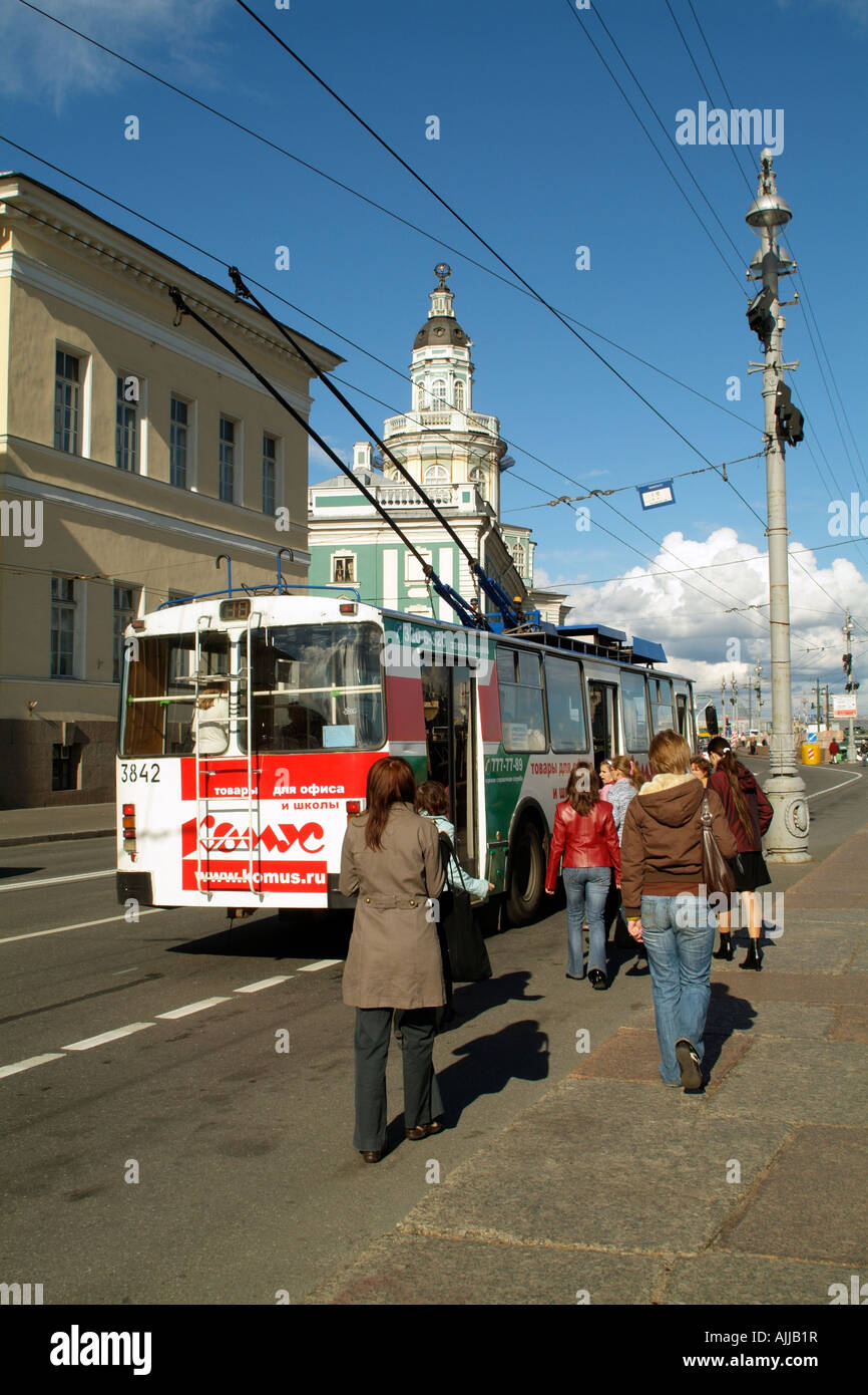 Trolley Bus Passengers Board a Commuter Tram near the Kunstkammer Building in St Petersburg Russia Stock Photo