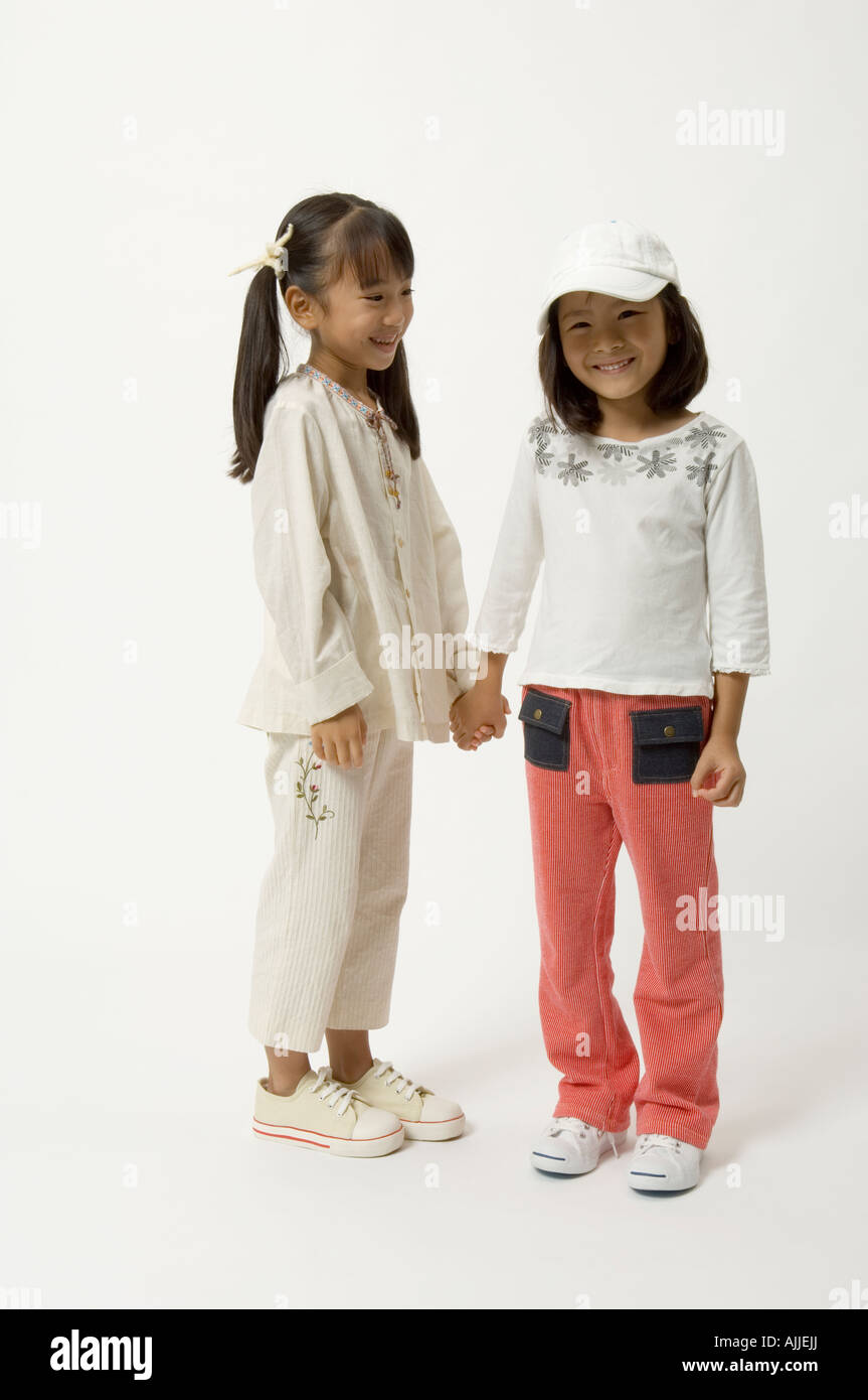 Two elementary age girls holding hands Stock Photo