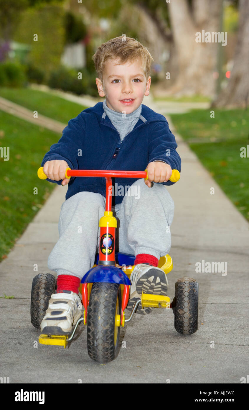 boy riding tricycle
