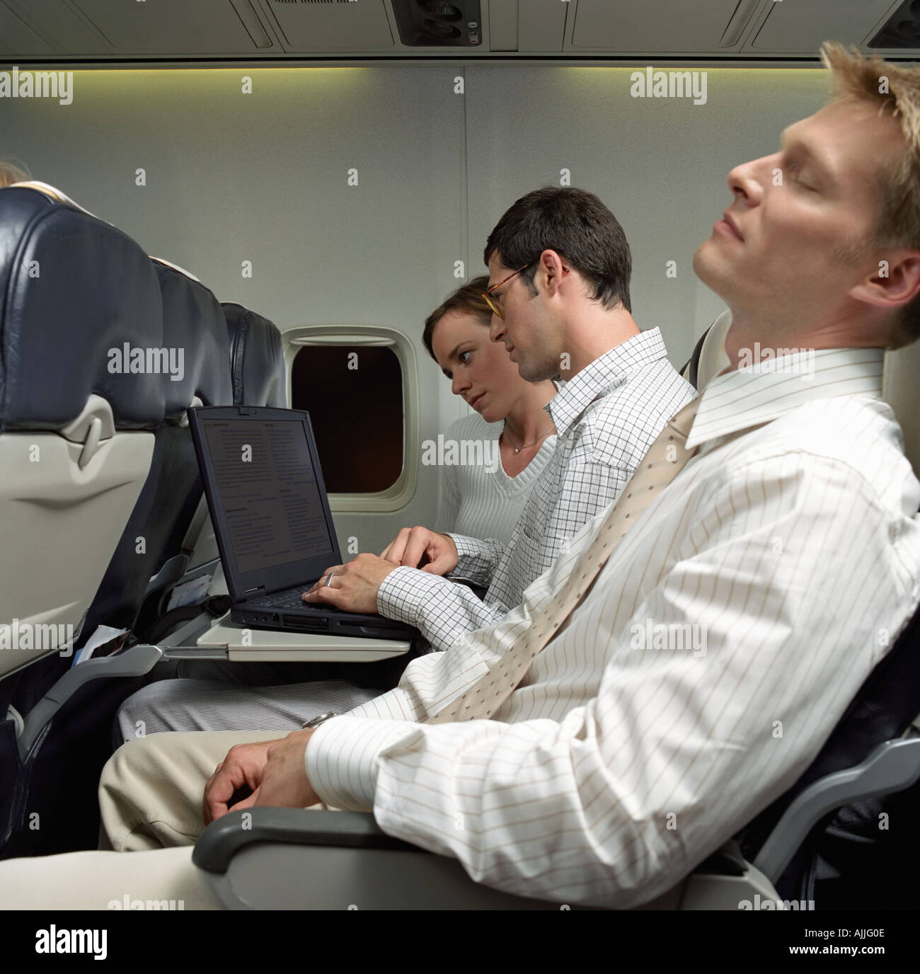 Business people on an aeroplane Stock Photo