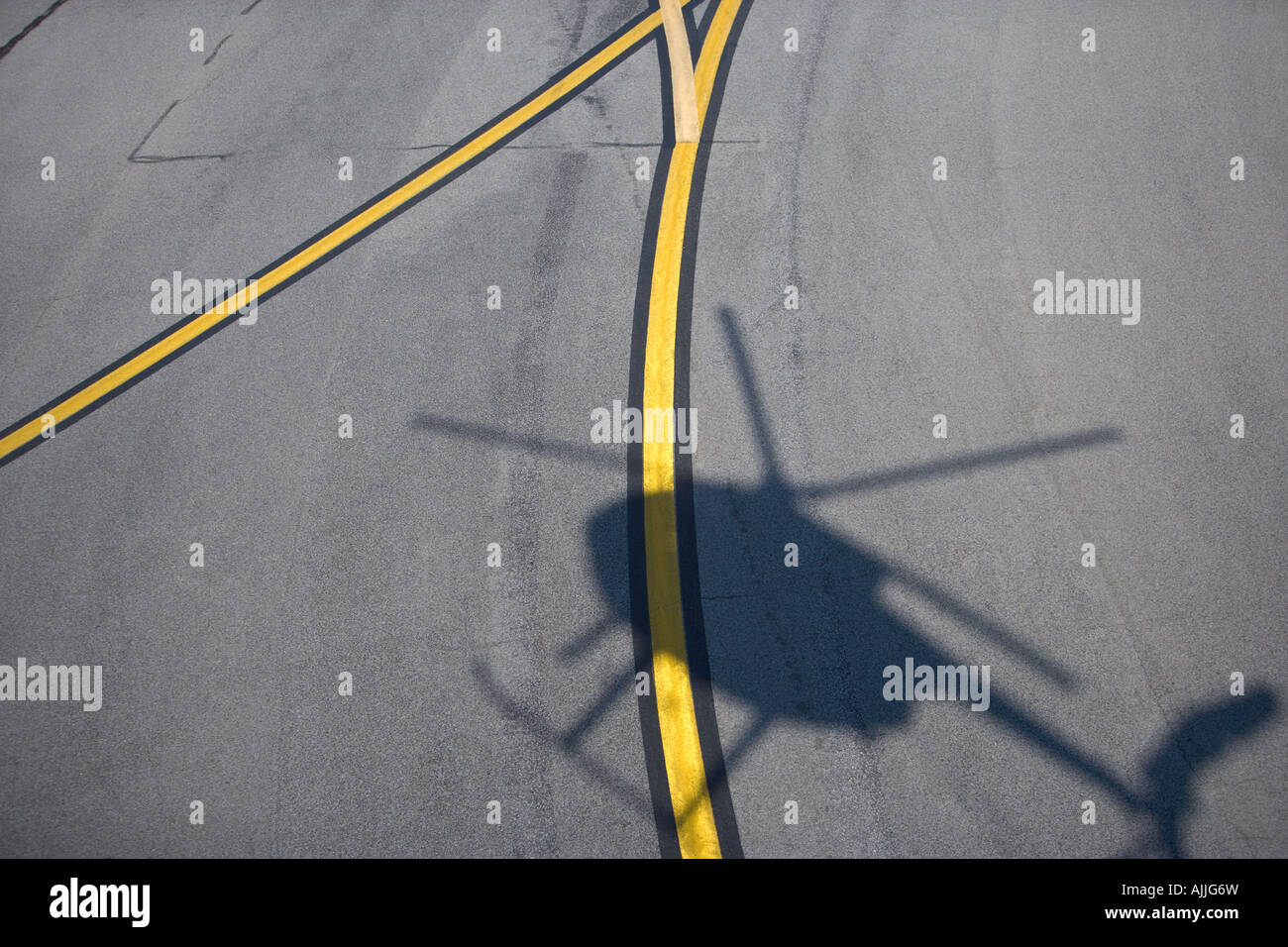 Shadow of MD 500 helicopter over runway, Virginia Beach, Virginia Stock Photo