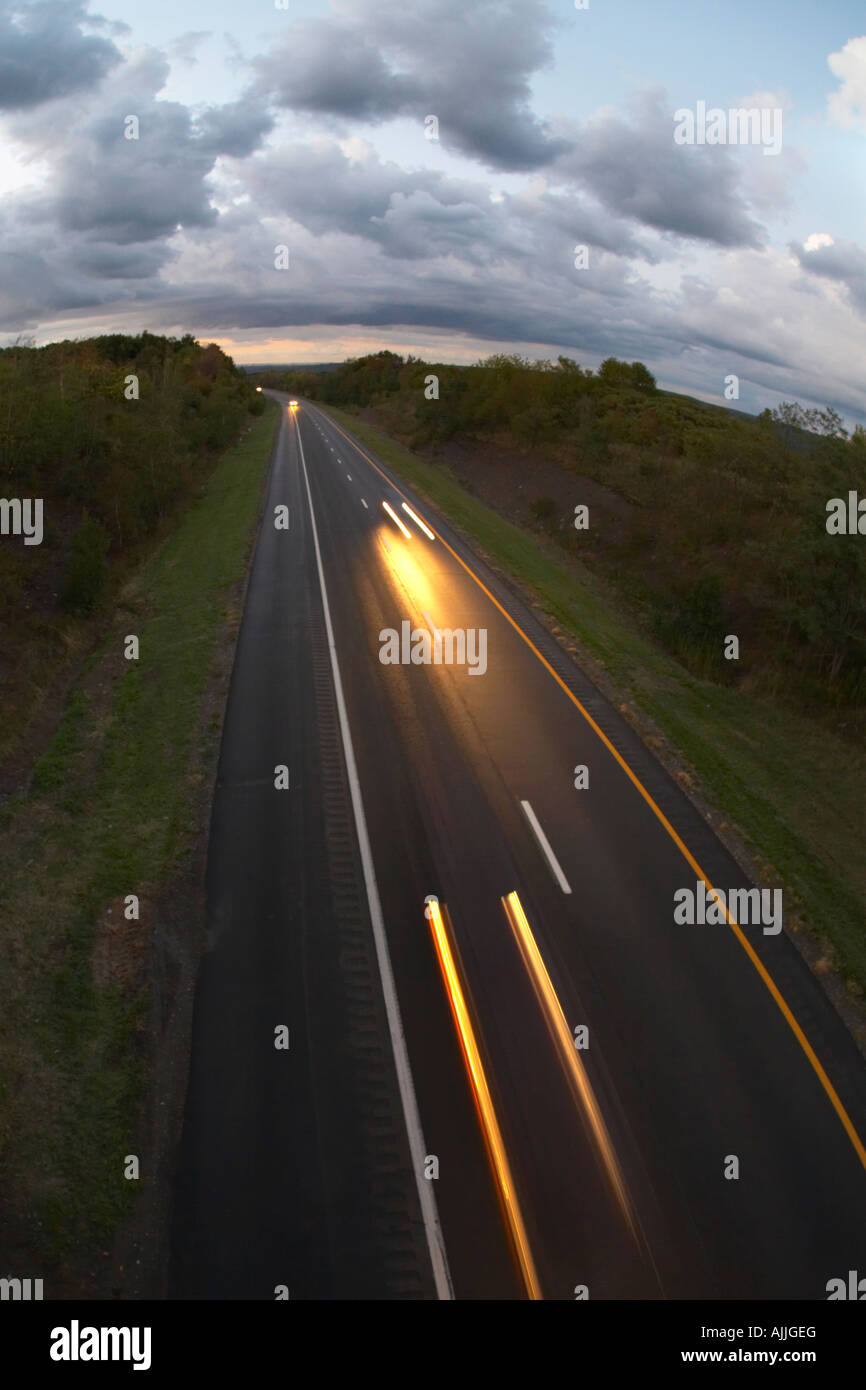 Overhead view of headlight streaks from cars on divided expressway at night Stock Photo