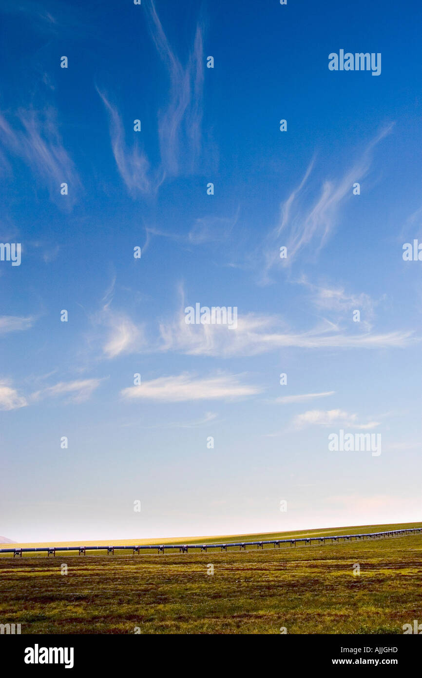 Cirrus clouds over trans alaska pipeline along Dalton Highway Gates of