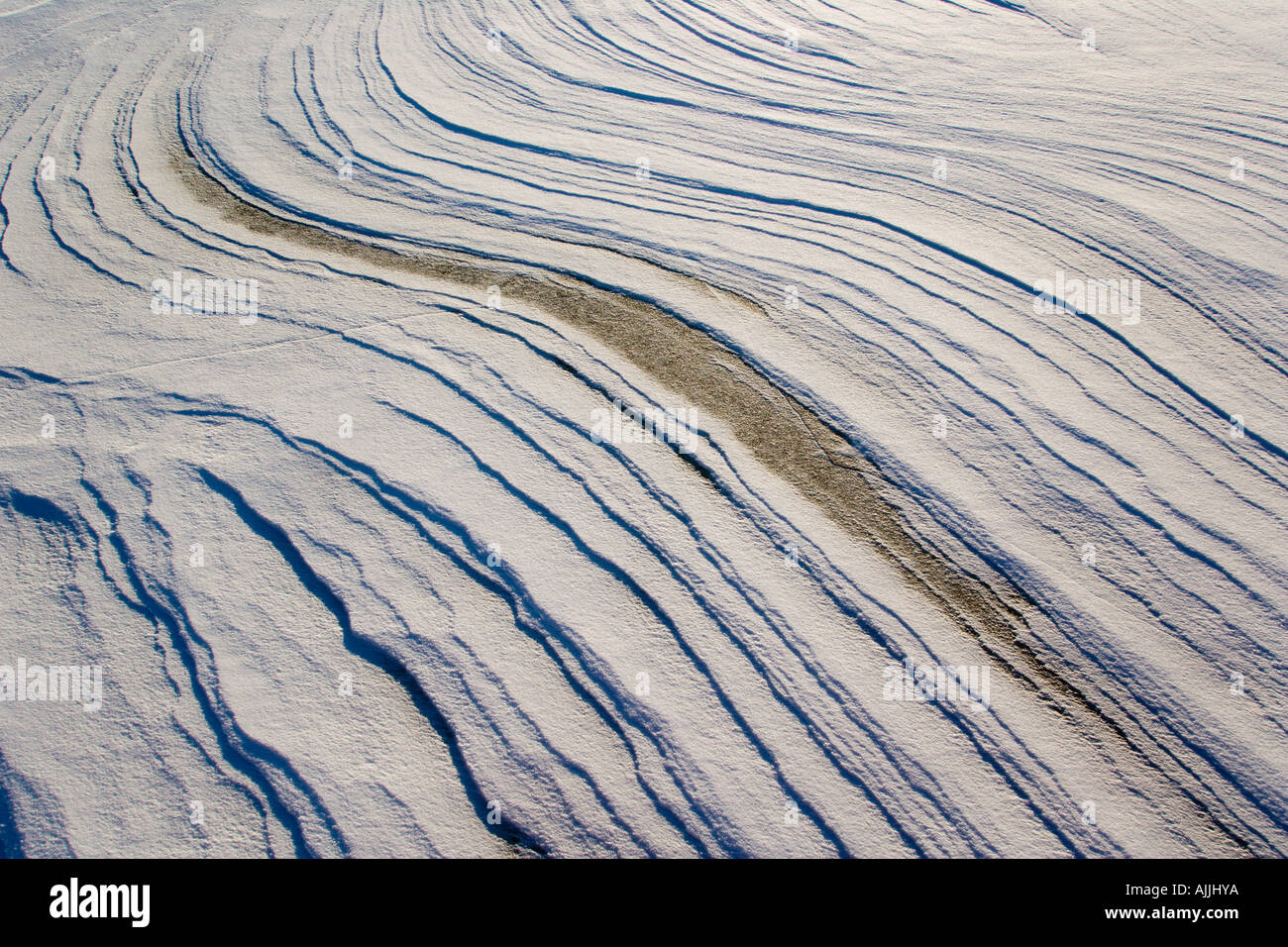 Windswept snow patterns on frozen Mendenhall Lake Southeast Alaska Winter Stock Photo