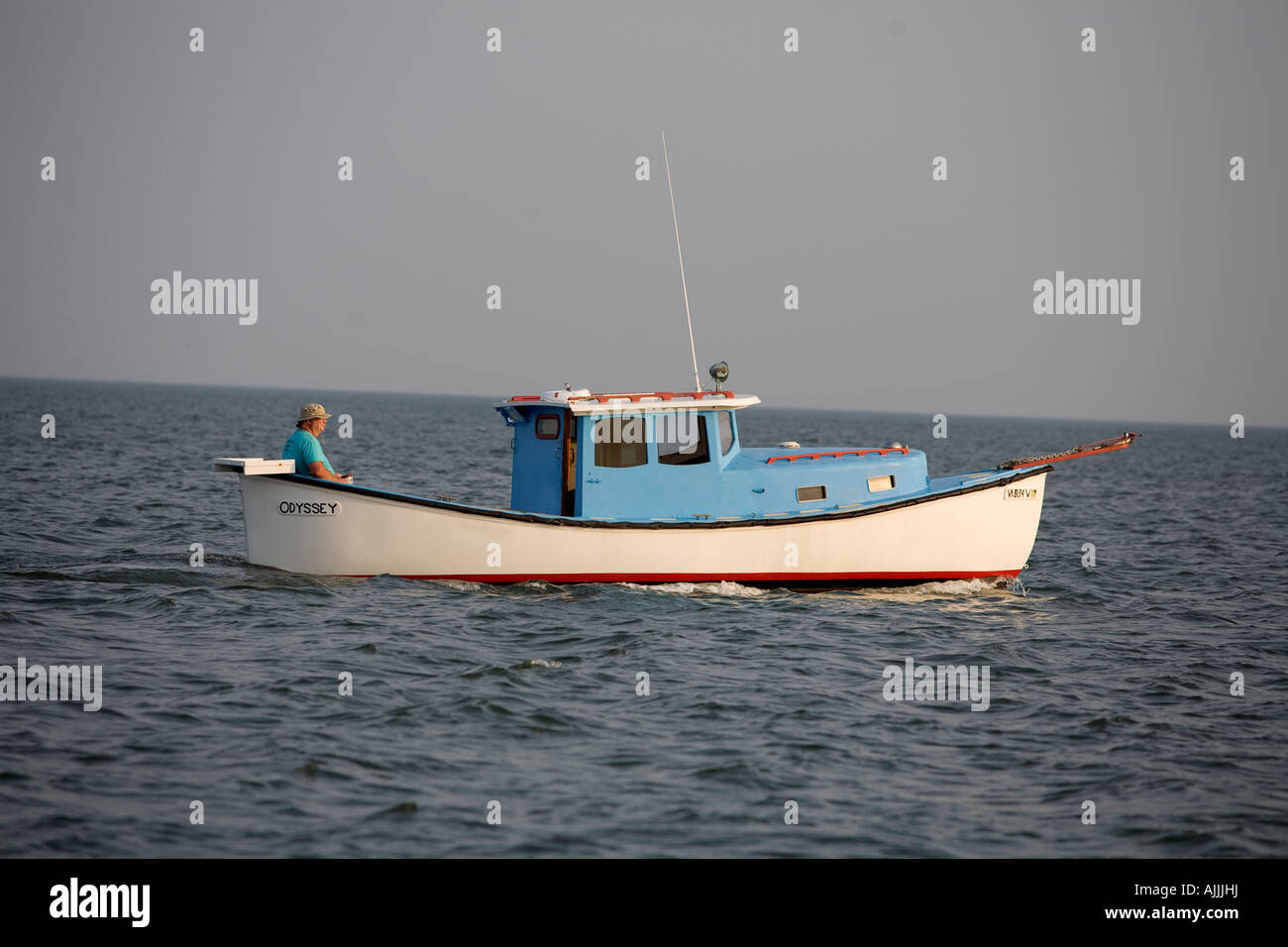 Man driving a small boat on Chesapeake Bay near Virginia Beach, Virginia, VA, USA Stock Photo
