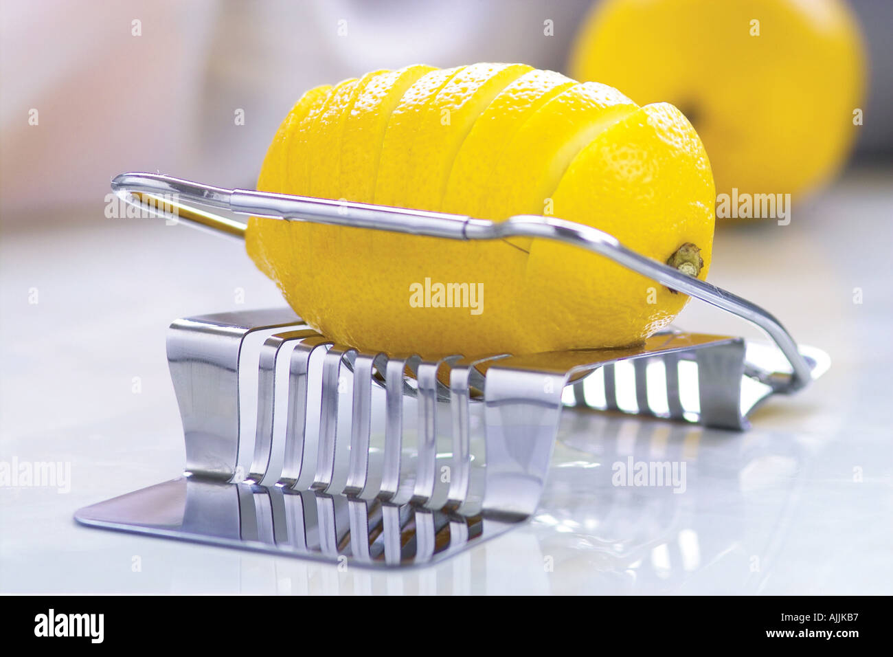 https://c8.alamy.com/comp/AJJKB7/close-up-of-lemon-in-a-slicer-AJJKB7.jpg