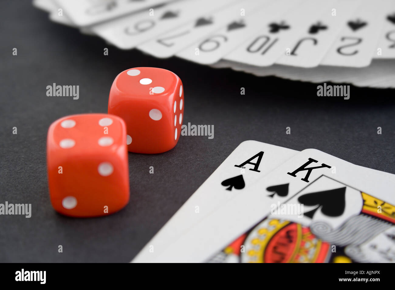 Playing Cards & Dice on Black Surface Stock Photo