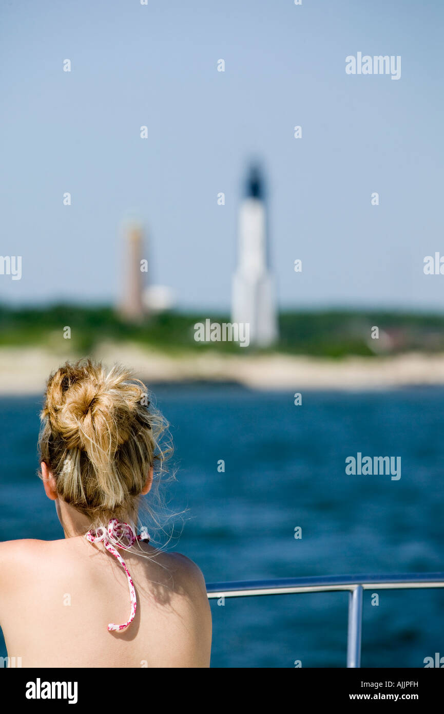 Young woman and lighthouses at Fort Story Virginia Beach VA Stock Photo