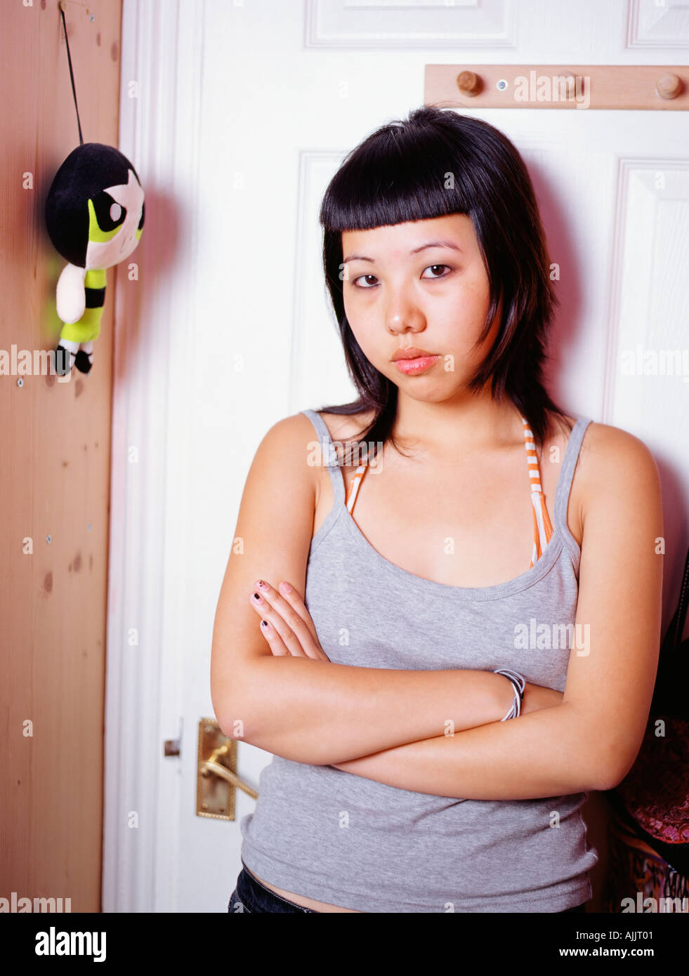Hostile teenage girl in bedroom Stock Photo