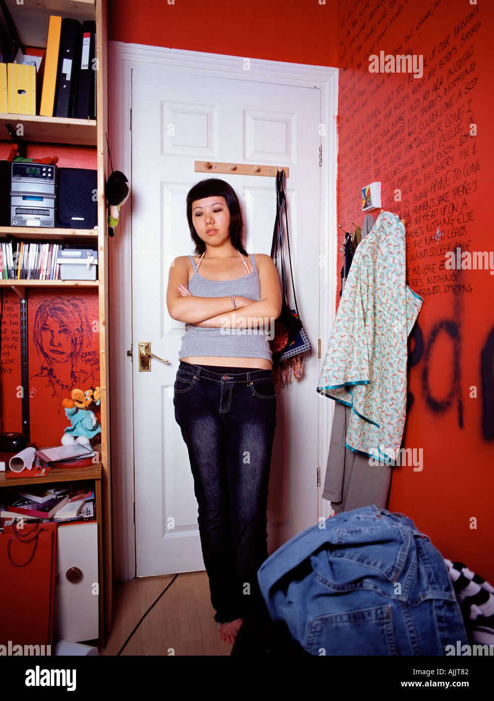 Hostile teenage girl in bedroom Stock Photo