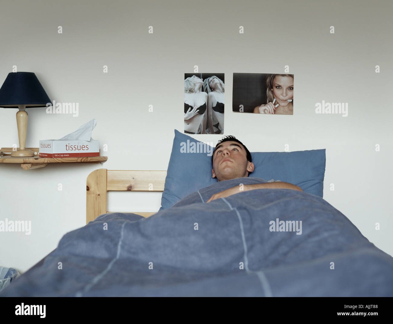 Teenage boy in bed Stock Photo