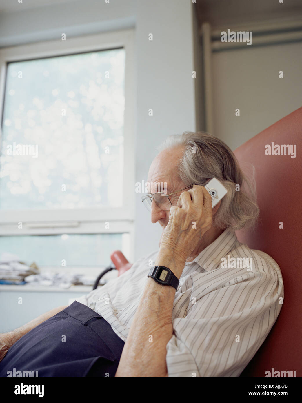 Elderly man using mobile phone Stock Photo