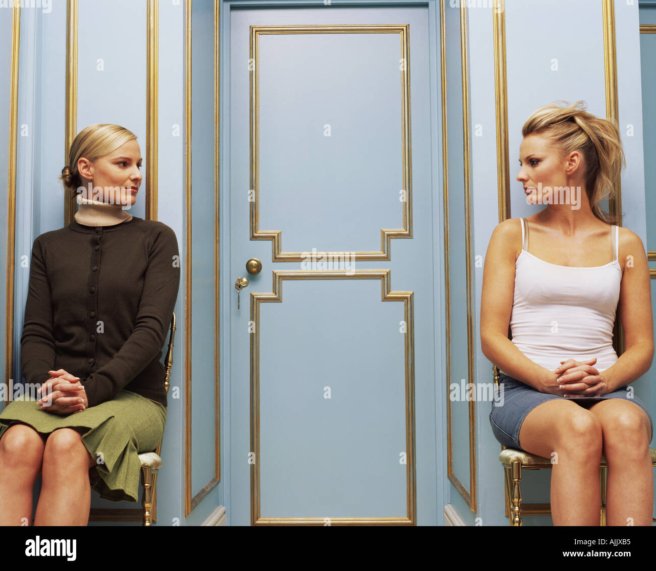 Two women on opposite sides of a doorway Stock Photo
